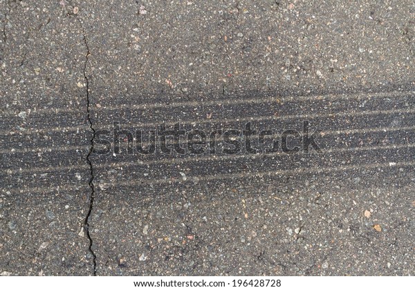 Tire tracks on\
asphalt