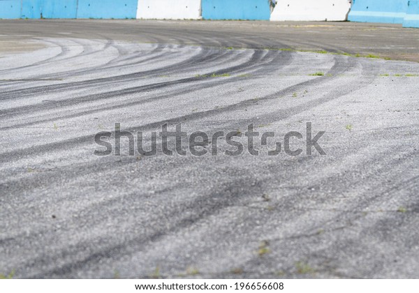 Tire tracks on\
asphalt