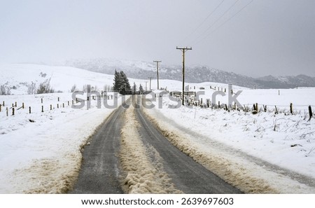 Tire tracks on a snow-covered slippery road. Ashburton Lakes. South Island.