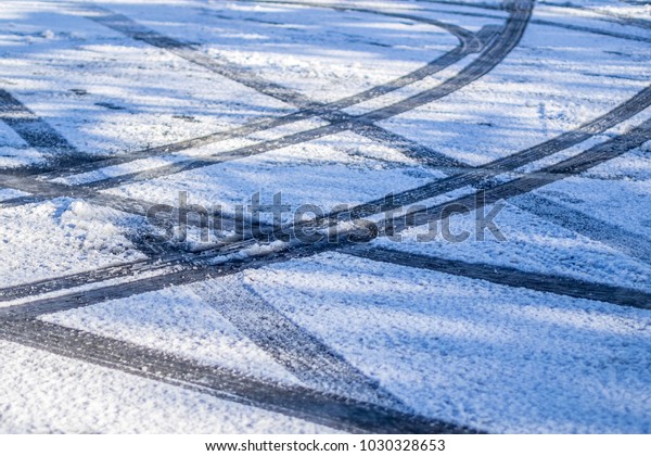 Tire\
tracks on a snowy parking lot in Somerville, USA.\
