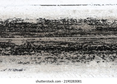 Tire tracks on a snowy road. View from above. Car wheel prints on a snowy road on a winter day