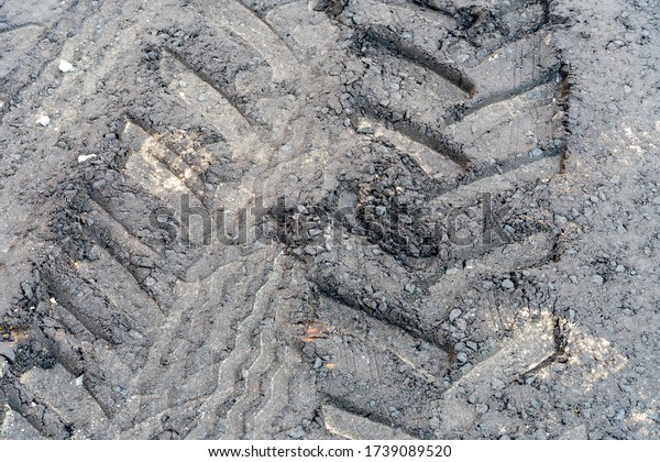 tire tracks on the soft asphalt. Road repairs,\
laying new asphalt.