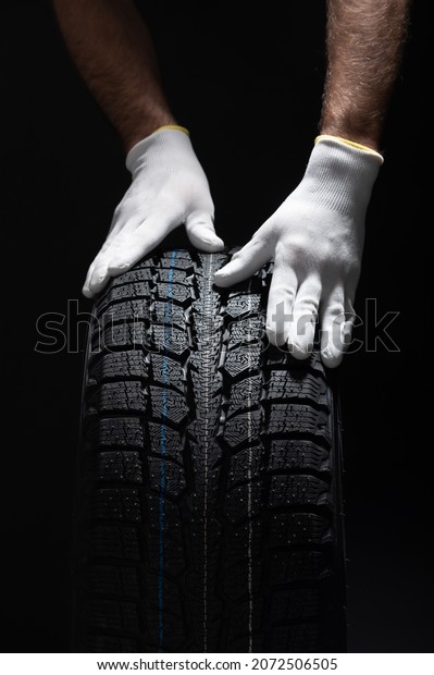Tire Trade with hands and gloves in a tire car\
service winter tires