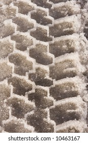 A Tire Tread From A Car Has Left A Deep, Rugged, Repetitive Pattern In The Snow Of A Road Near Aspen, Colorado. The Crystals Of The Ice Are Clearly Visible.