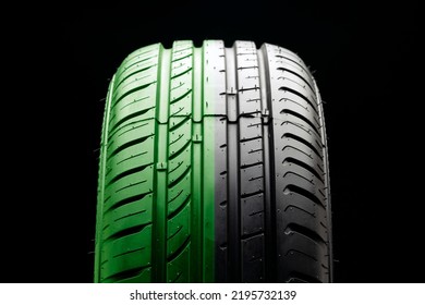 Tire Tread Close-up, Half Green. The Concept Of An Eco-friendly Economical Tire, Fuel Economy And Safety