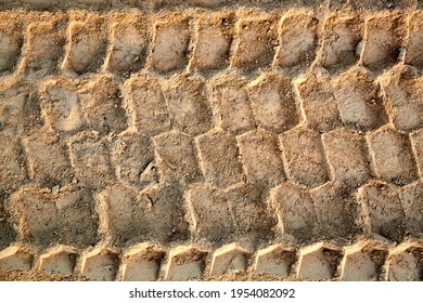 Tire tread footprints of a dump truck on the sand. Construction site. Pattern. Brown abstract background. Car wheelprint. Textured ground. Tyre drawing. - Shutterstock ID 1954082092