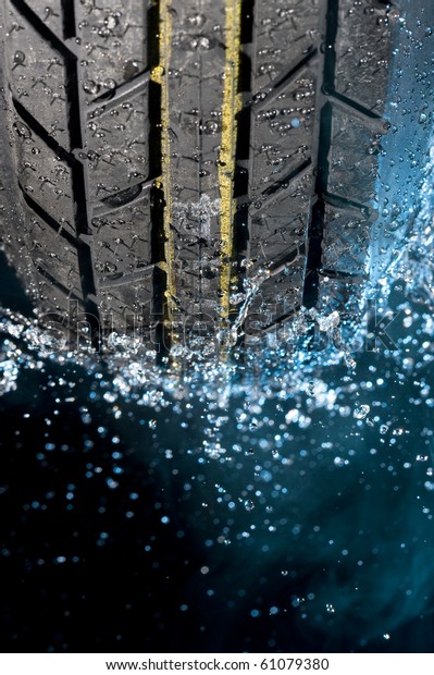 Tire with water\
drops on it smoke\
background