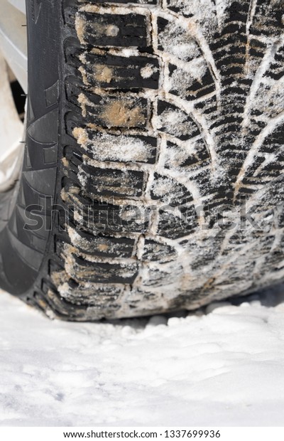Tire for winter with spikes and its imprint on the\
road covered with snow