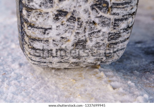 Tire for winter with spikes and its imprint on the
road covered with snow