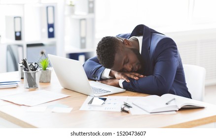Tired african american young businessman sleeping in his office, overworking concept, panorama with copy space