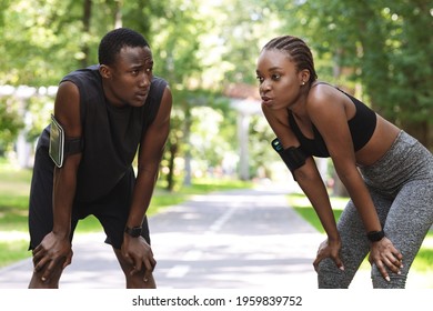 Tired African Couple Taking Breath After Hard Workout Outdoors, Resting Together, Standing On Path In Park, Free Space - Powered by Shutterstock