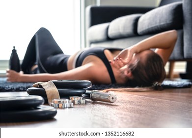 Tired After Exercise And Workout. Overtraining Concept. Exhausted Woman Lying On Floor Breathing And Resting After Heavy Cardio Training In Home Gym. Sad Fitness Athlete. Too Much Working Out.