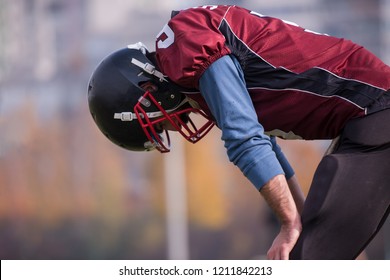 A tired american football player resting after hard training at field - Powered by Shutterstock