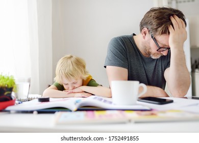 Tired And Angry Father Trying Help His Son Doing Homework, But Bored Child Refusing. Homeschooling, Online Studying, Remote Education For Kids During Quarantine Is A Problems For Many Parents.