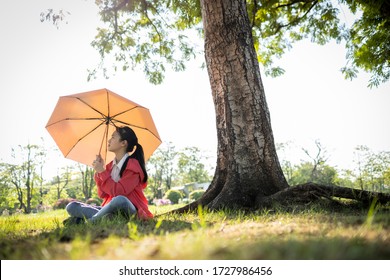Tired Asian Child Girl Is Holding Umbrella Uv To Covering Face Skin,protection From Sunlight Ray,high Temperature On Sunny Day,prevent Heatstroke,sunburn Very Hot In Summer Weather Problem,feel Faint