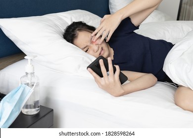 Tired Asian Teenager Girl Rubbing Her Eyes,itchy,pain And Eye Strain While Watching Movies Online From Mobile Phone For A Long Time On Her Bed At Night,Don't Rub Eyes With Dirty Hands,vision Problem 