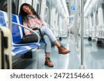 Tired asian woman fell asleep in the subway car