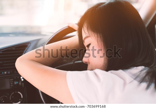 Tired asian woman  sleep in\
car.