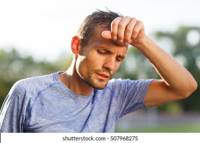 Tired Athlete Wiping With Hand Sweat From Forehead Closeup