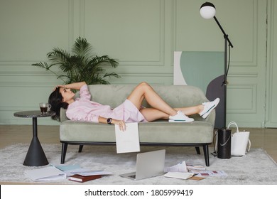 Tired Beautiful Business Woman Lying Down On The Sofa.