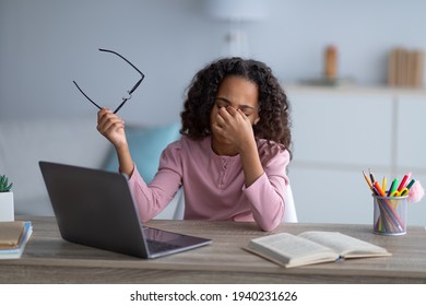 Tired Black Schoolgirl Rubbing Dry Irritated Eyes, Studying Online On Laptop At Home