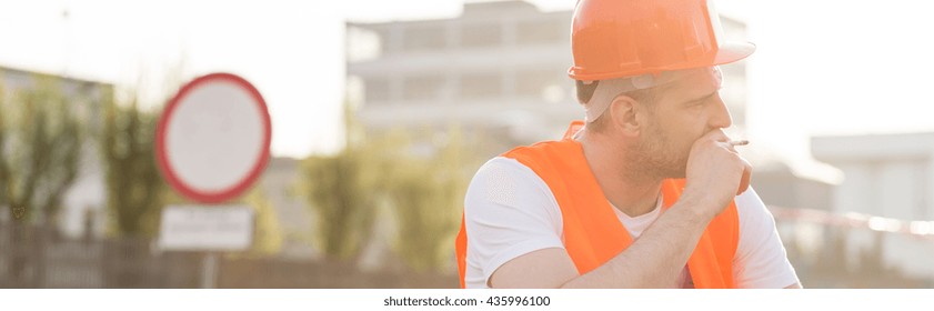 Tired Blue Collar Worker With A Cigarette 