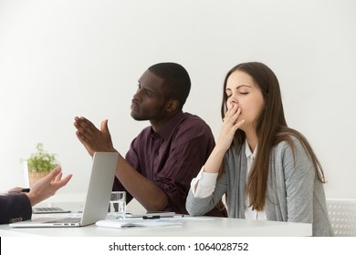 Tired Bored Businesswoman Yawning At Boring Office Meeting With Diverse Colleagues Or Partners, Young Lazy Employee Or Dull Intern Showing Bad Manners, Impolite Behavior, Suffering From Lack Of Sleep