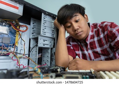 Tired And Bored Computer Repairman Is Sitting On His Workplace And Thinking.