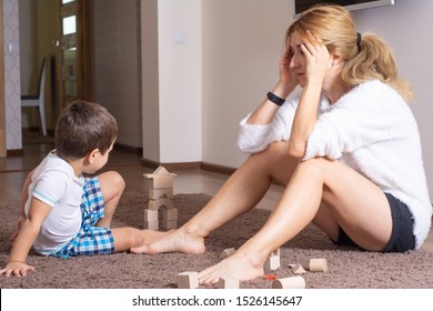 Tired And Bored Mother With 3 Years Old Boy At Home. 3 Year Old Children’s Behavior Crisis