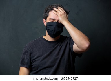 Tired Brunet Man In In Black Facemask On Dark Background