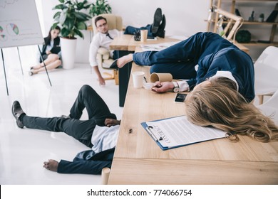 Tired Business Colleagues Sleeping At Office