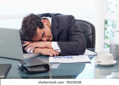 Tired businessman sleeping in his office - Powered by Shutterstock