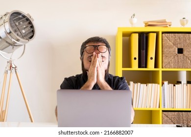 Tired Businessman, Young Tired Businessman Rubbing His Eyes. Confused, Frustrated, Sad Or Depressed Young Worker. Front View Young Man Using Laptop And Feeling Desperate.