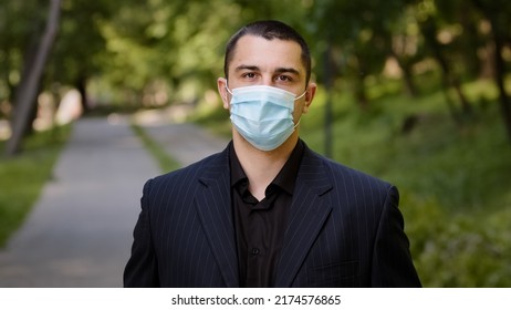 Tired Caucasian Businessman Takes Off Medical Face Mask Protective Respirator Exhausted Man Guy Stands In City Park Feels Freedom Makes Deep Breath Fresh Air Outside Relief End Of Pandemic Quarantine