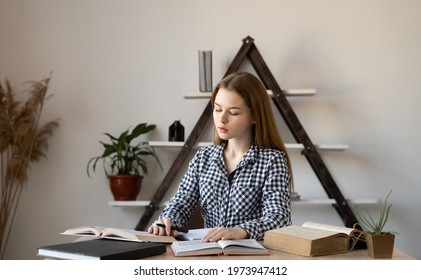 Tired Caucasian Girl Student Consultant Or Teacher Preparing For A Lecture By Reading Several Books Of Encyclopedia Reference Books, Studying The Material. Online Education, Distance Learning Concept.