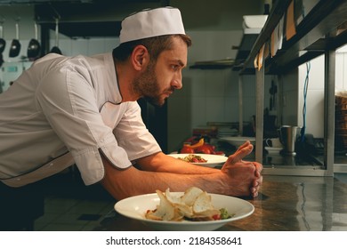 Tired chef on kitchen restaurant waiting for a new order - Powered by Shutterstock