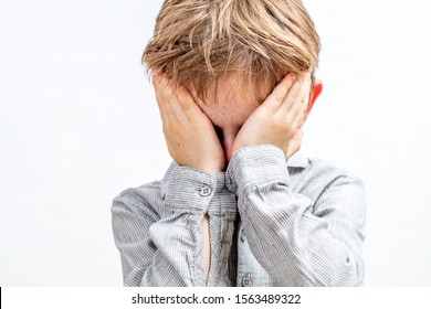 tired child scratching eyes, crying or feeling bored, shy or playing peekaboo, isolated closeup portrait over white background