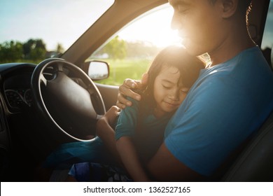 Tired Child Sleeping On Father's Lap While He Is Driving A Car