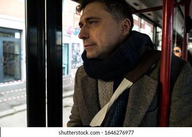 Tired Commuter In A Bus Looking Out The Window