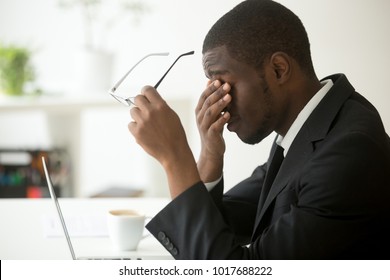 Tired Of Computer African Businessman Taking Off Glasses Feels Eye Strain Fatigue After Long Office Work On Laptop, Exhausted Overworked Stressed Depressed Black Man Having Bad Sight Vision Problem