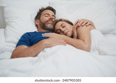 Tired, couple and cuddle with sleep in bedroom for marriage, commitment and comfort in love at home. Partner, peace and man with embrace of woman in house for dream, rest and afternoon nap on weekend - Powered by Shutterstock