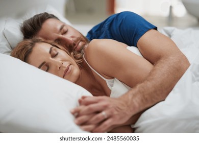 Tired, couple and sleeping with cuddle in bed for dreaming, commitment or peace in rest at home. Love, partner and woman with embrace of man in house for marriage, comfort or afternoon nap on weekend - Powered by Shutterstock