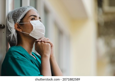 Tired Depressed Female Asian Scrub Nurse Wears Face Mask Blue Uniform Sits On Hospital Floor,Young Woman Doctor Stressed From Hard Work