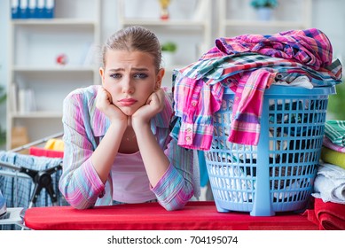 Tired Depressed Housewife Doing Laundry