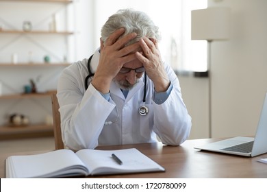 Tired depressed old male doctor feels desperate thinking of medical problem feels burnout at work. Worried upset senior physician regrets medical malpractice suffers from guilt sits alone in office. - Powered by Shutterstock