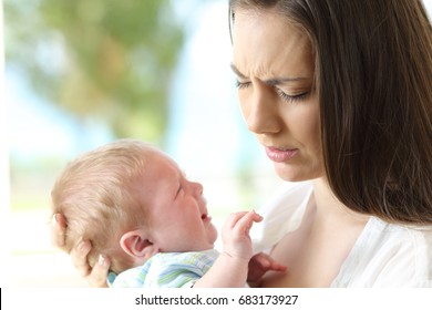 Tired Desperate Mother Holding Her Baby Crying