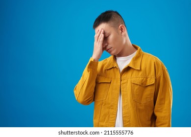 Tired Disappointed Young Man Making Face Palm Gesture, Isolated On Blue