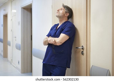 Tired Doctor After Long Day At Work