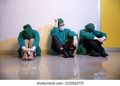 Tired doctor, Group of surgery doctors sadness fatigue after surgery, emotional sitting stress of overworked doctor and medical care team during covid-10, Surgical team tired after operation - Powered by Shutterstock