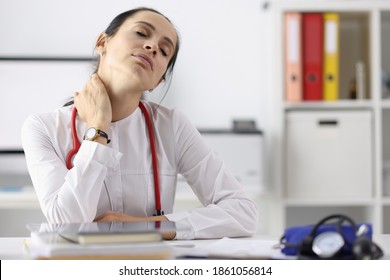 Tired Doctor In Office After Working Day. Medical Fatigue In Coronavirus Pandemic Concept